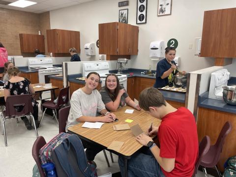 FCCLA Members Pose While writing notes to teachers 