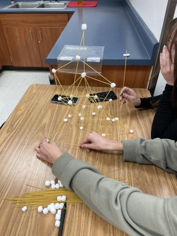 kids build a spaghetti tower with marshmallows  