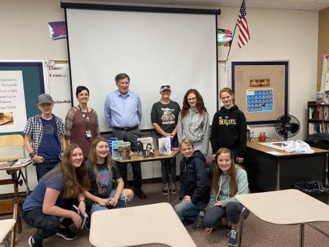Students of the writing club and author Chris Crow pose for the camera 