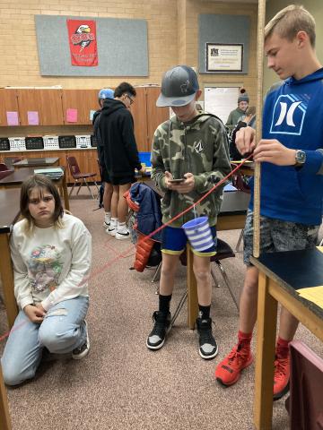 Students experiment in the class by making mini zipline 