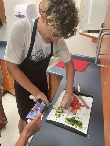 a student cuts veggies 